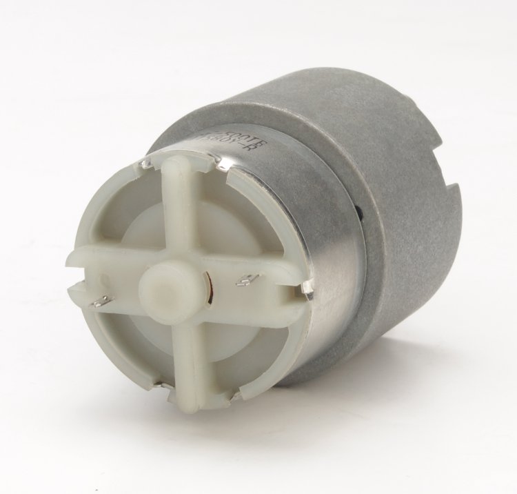 Small DC gear motor with cylindrical metal housing and plastic front gear assembly